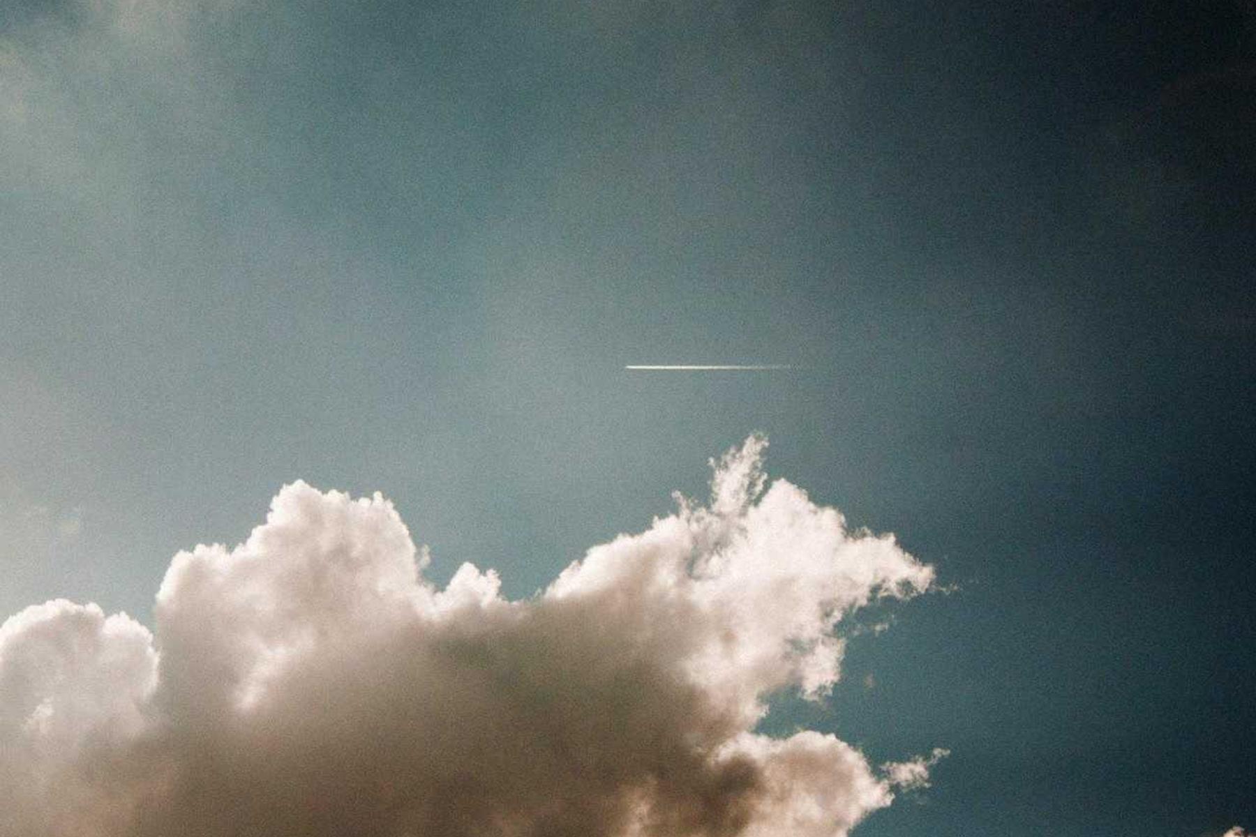 A woman in a flowing white dress in a bright, airy room.